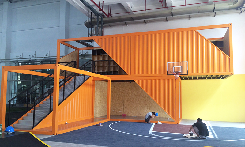 Stacked orange modified containers used as a commercial building