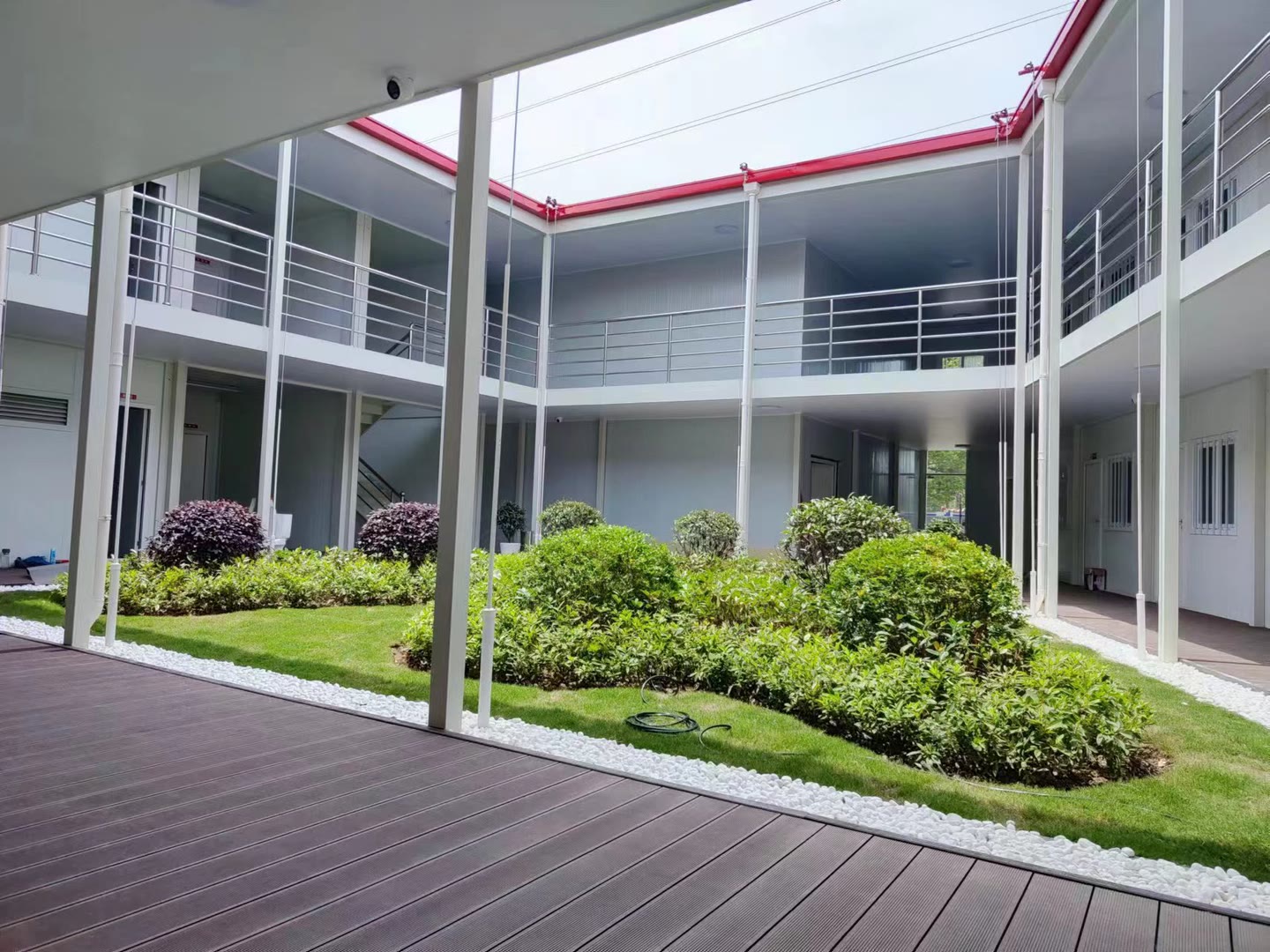 Covered walkway overlooking the landscaped courtyard of a completed modular office campus