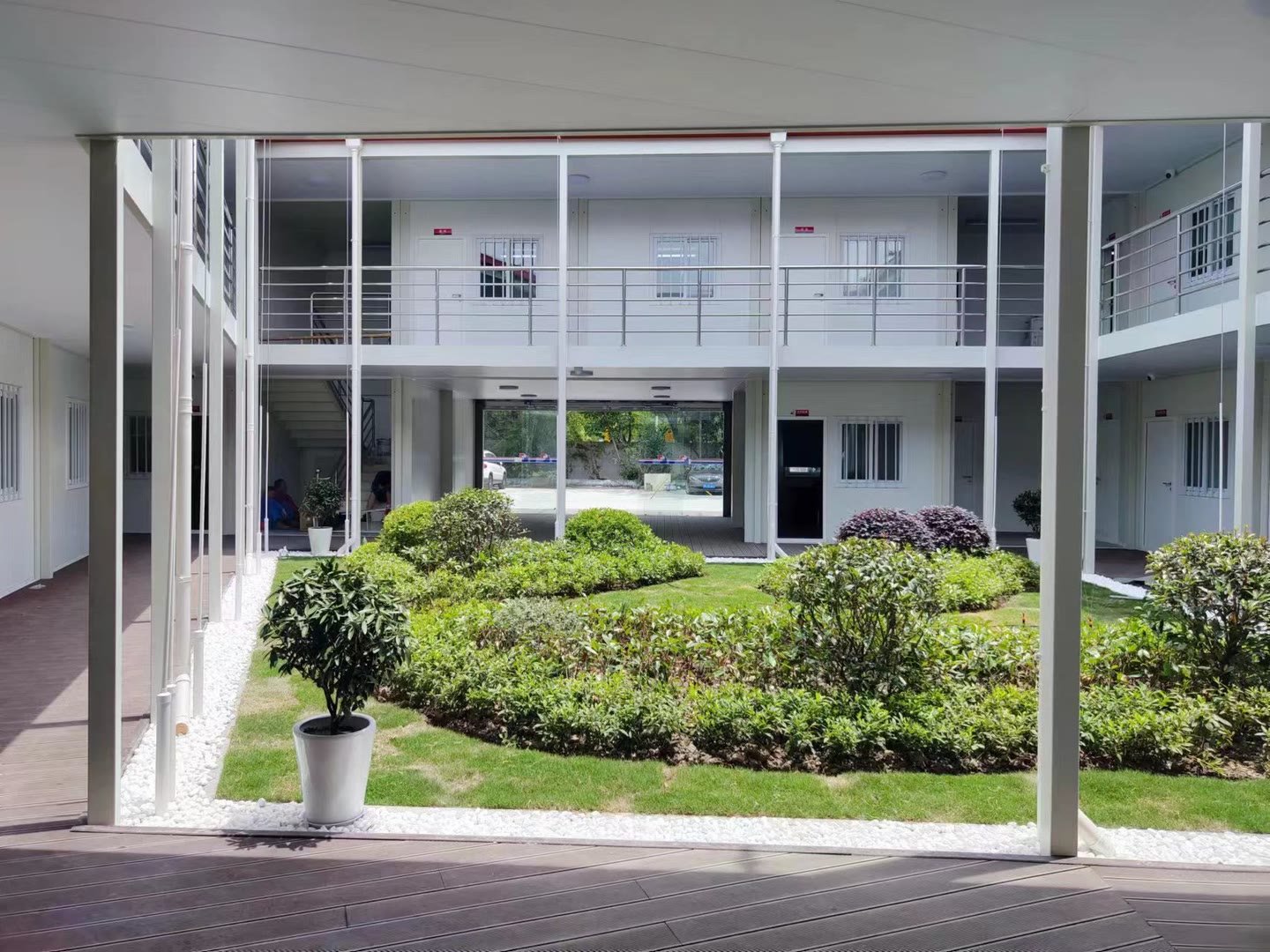 Two-storey modular office buildings surrounding a central garden