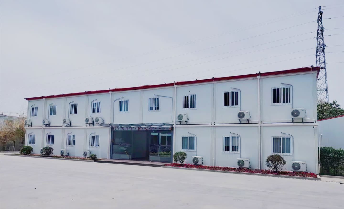 Completed white modular office building with a glazed entrance